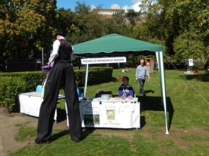 The Friends gazebo with passing stiltwalker